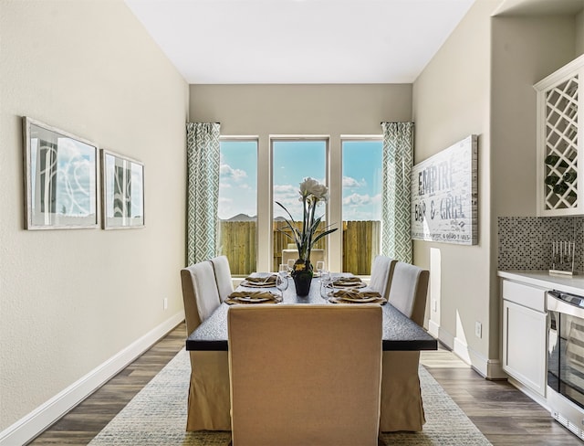 dining area featuring dark wood-type flooring and wine cooler