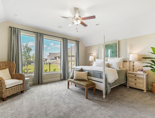 bedroom featuring multiple windows, ceiling fan, and lofted ceiling