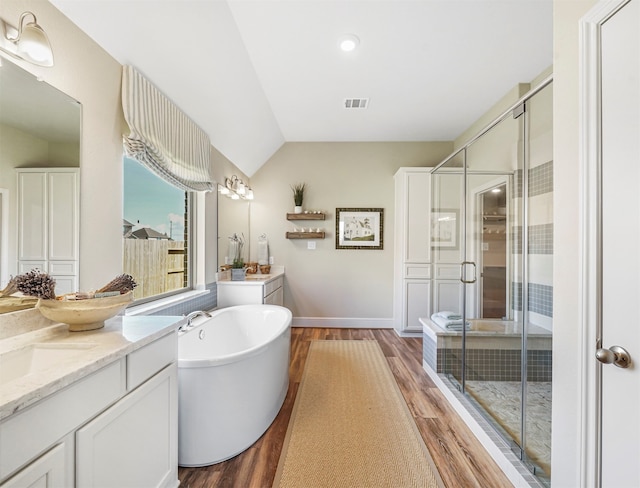 bathroom with plus walk in shower, wood-type flooring, vanity, and vaulted ceiling