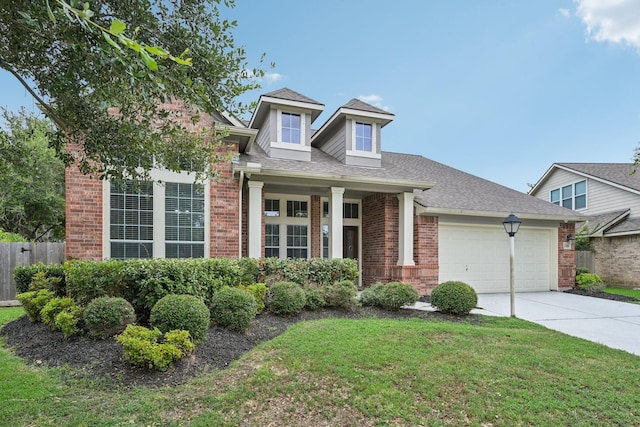 view of front facade featuring a front yard and a garage