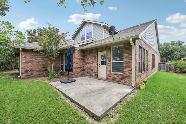 view of front of home with a patio and a front yard