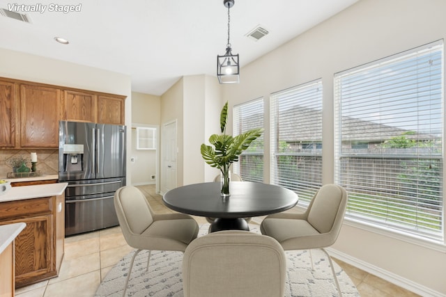 dining room with light tile patterned floors and a wealth of natural light