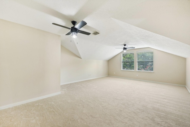 bonus room featuring ceiling fan, light colored carpet, and vaulted ceiling