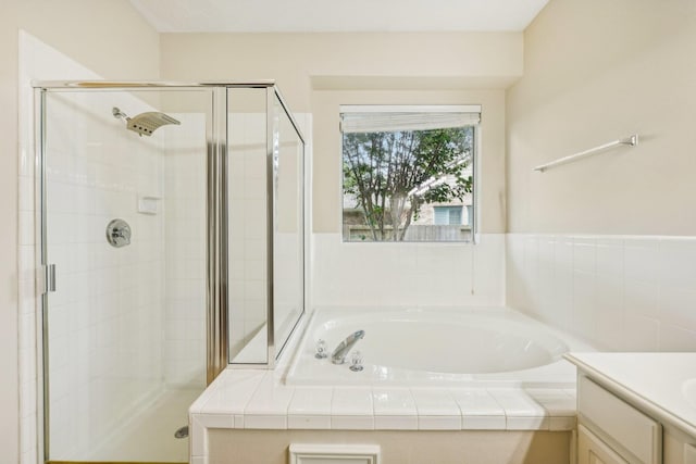 bathroom featuring vanity and independent shower and bath