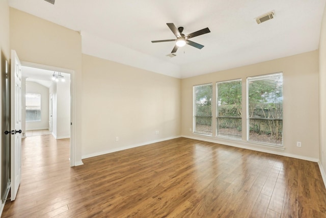 unfurnished room featuring ceiling fan, plenty of natural light, and wood-type flooring