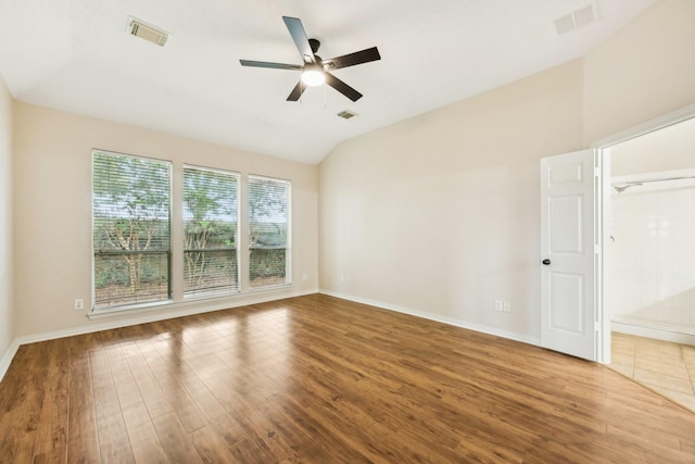 spare room featuring hardwood / wood-style flooring, vaulted ceiling, and ceiling fan