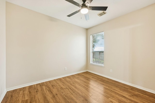 spare room with ceiling fan and wood-type flooring