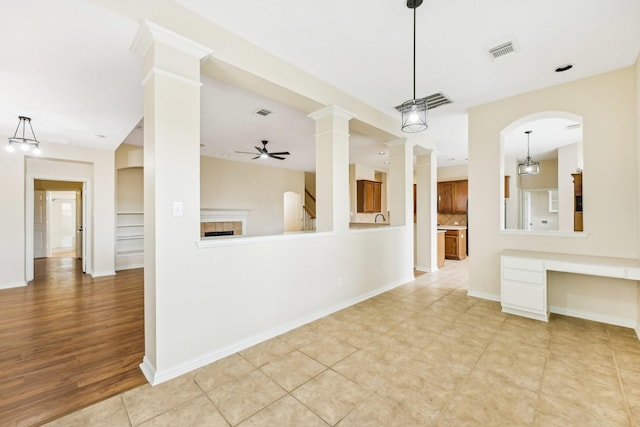 kitchen featuring ceiling fan, light tile patterned flooring, decorative backsplash, and decorative light fixtures