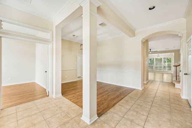 unfurnished room featuring ornate columns, light tile patterned floors, and ornamental molding