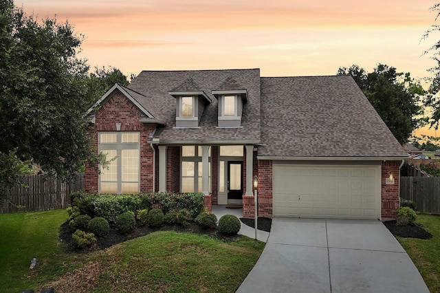 view of front facade featuring a garage and a yard