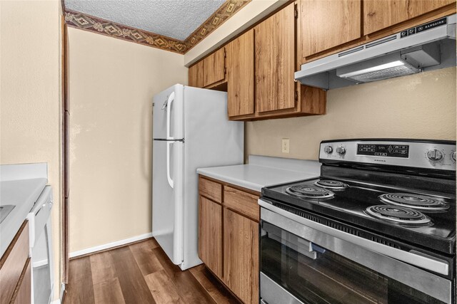 kitchen with dark wood-type flooring, a textured ceiling, stainless steel electric stove, and white refrigerator