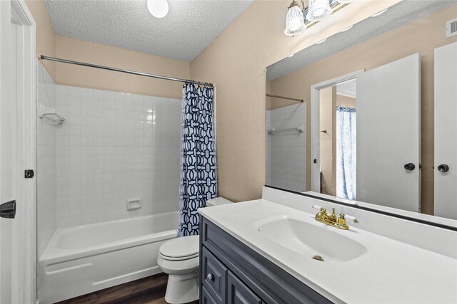 full bathroom with hardwood / wood-style flooring, a textured ceiling, toilet, shower / bath combination with curtain, and vanity