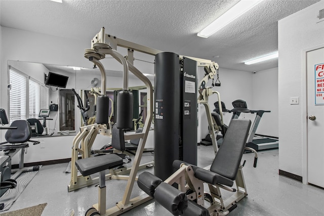 workout area featuring a textured ceiling