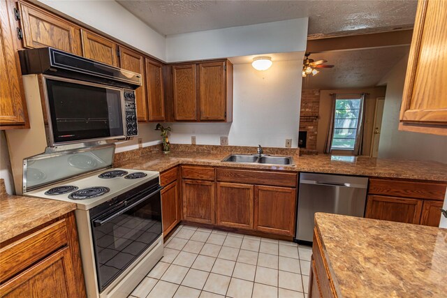 kitchen with kitchen peninsula, ceiling fan, sink, white electric stove, and dishwasher