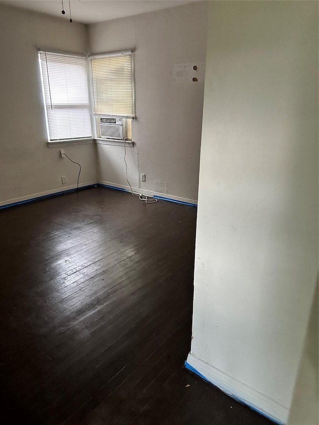 empty room featuring dark wood-type flooring and cooling unit