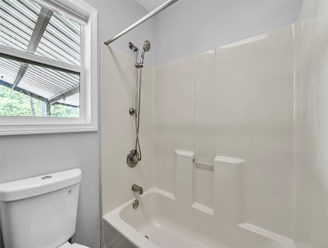 bathroom with shower / washtub combination and toilet