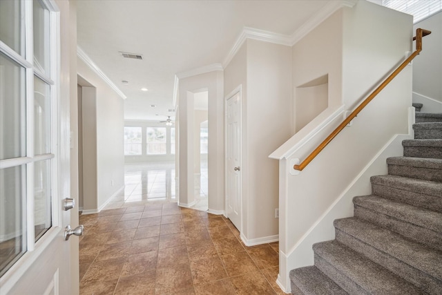 stairway with ceiling fan and ornamental molding