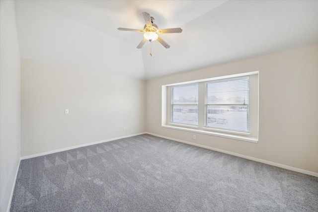 carpeted empty room featuring ceiling fan and lofted ceiling