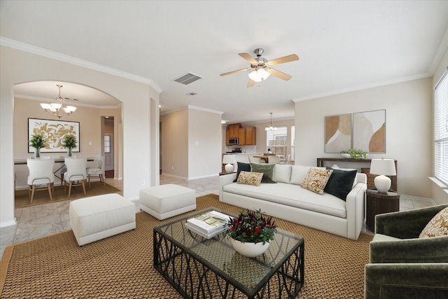 living room with ceiling fan with notable chandelier and ornamental molding