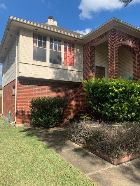 view of side of home featuring a lawn