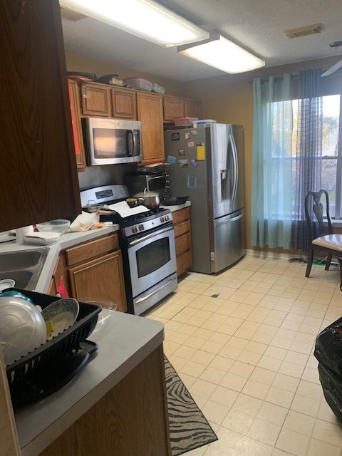 kitchen featuring sink, appliances with stainless steel finishes, and light tile patterned floors