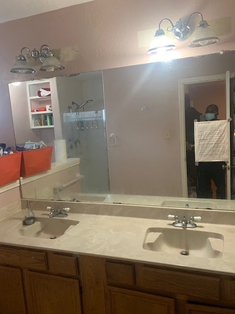 bathroom featuring dual vanity