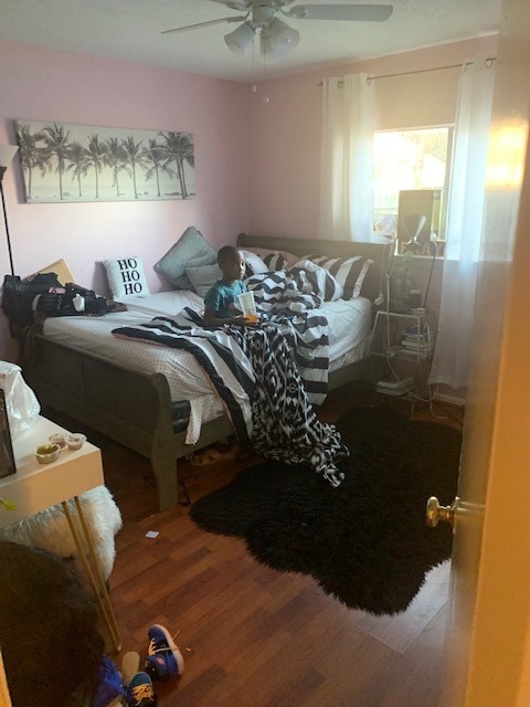 bedroom featuring ceiling fan and hardwood / wood-style floors