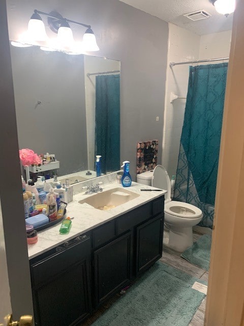 bathroom with toilet and vanity