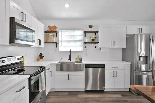 kitchen featuring appliances with stainless steel finishes, dark hardwood / wood-style flooring, sink, and white cabinets