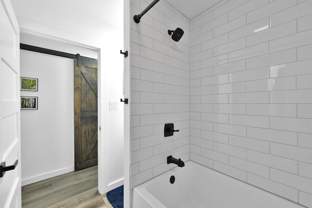 bathroom featuring hardwood / wood-style floors and tiled shower / bath combo