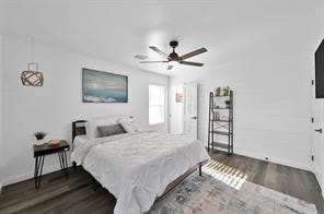 bedroom featuring ceiling fan and dark wood-type flooring