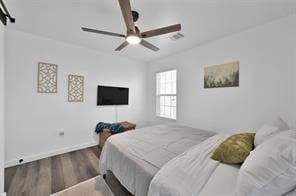 bedroom with ceiling fan and hardwood / wood-style flooring