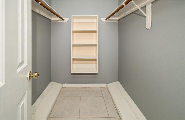 spacious closet with light tile patterned floors