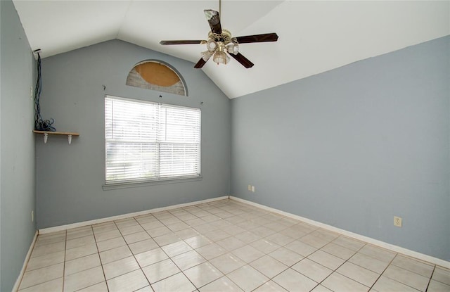 empty room featuring ceiling fan, light tile patterned flooring, and vaulted ceiling