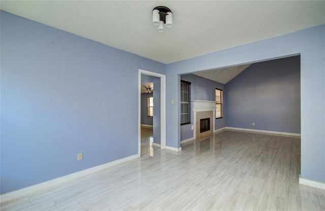 unfurnished living room with lofted ceiling