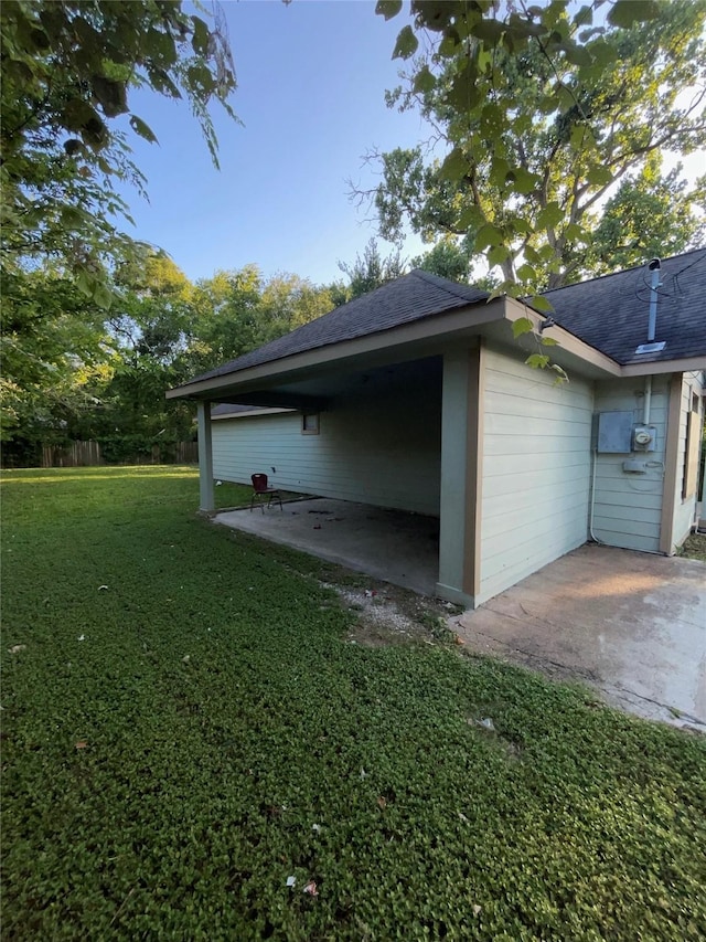 view of side of property with a yard and a patio area