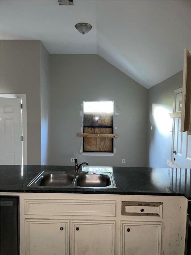 kitchen featuring white cabinetry, sink, lofted ceiling, and black dishwasher