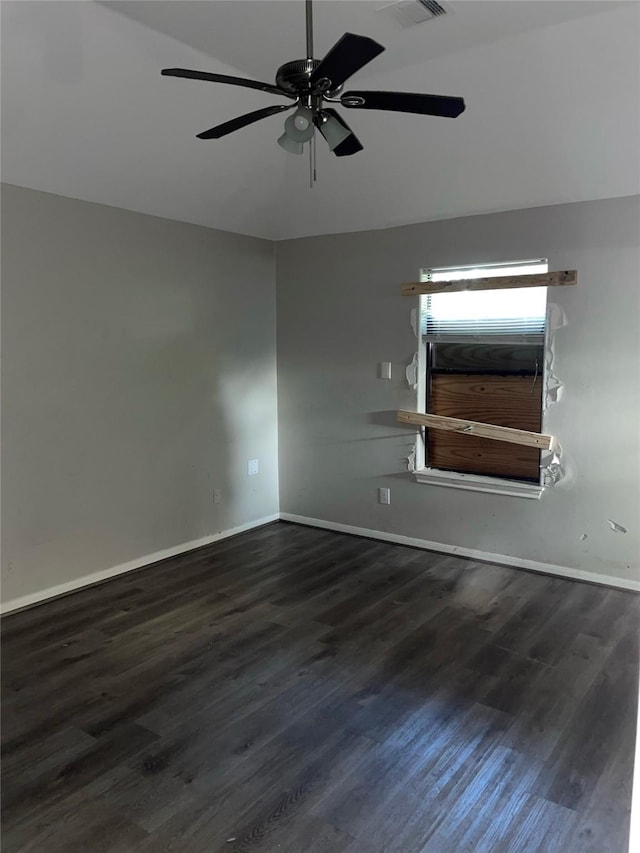 spare room featuring dark hardwood / wood-style floors, ceiling fan, and lofted ceiling