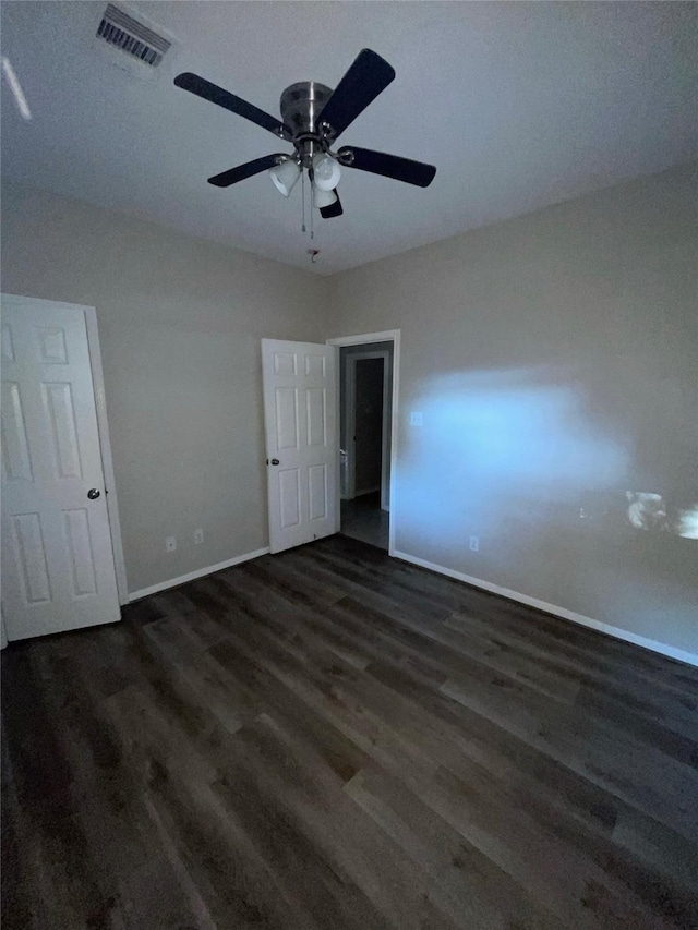 unfurnished bedroom with ceiling fan and dark hardwood / wood-style floors