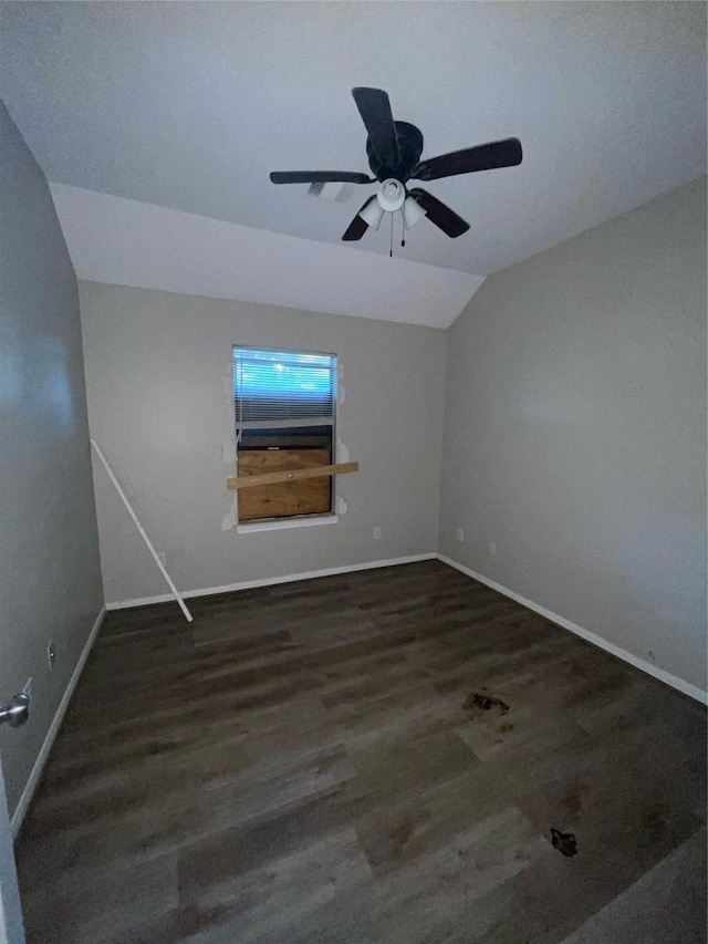 spare room with ceiling fan, dark wood-type flooring, and lofted ceiling