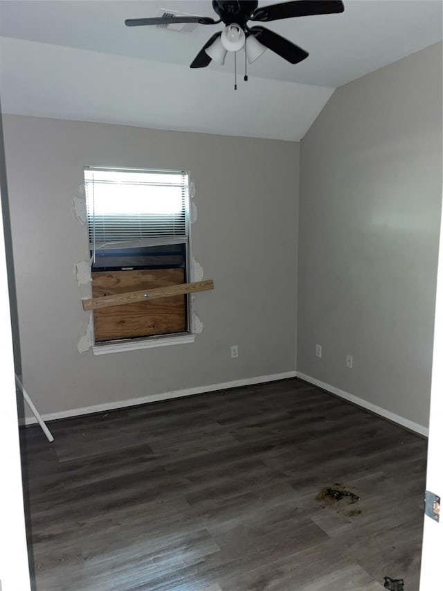 empty room featuring ceiling fan, dark hardwood / wood-style flooring, and lofted ceiling