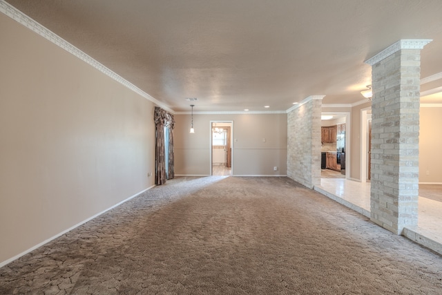 unfurnished room featuring light carpet, decorative columns, and ornamental molding