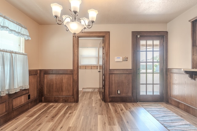 interior space featuring a chandelier and light wood-type flooring