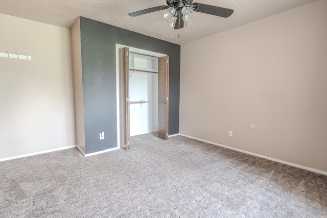 unfurnished bedroom featuring carpet floors, a textured ceiling, and ceiling fan