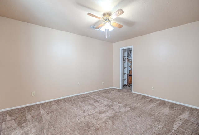 unfurnished room with carpet and ceiling fan