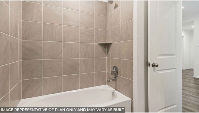 bathroom featuring hardwood / wood-style floors and tiled shower / bath