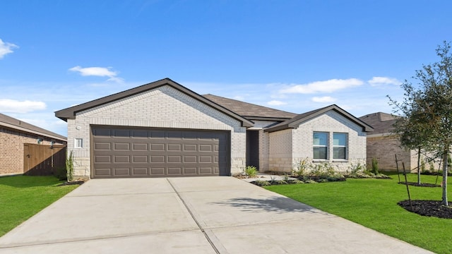 single story home with a garage and a front lawn