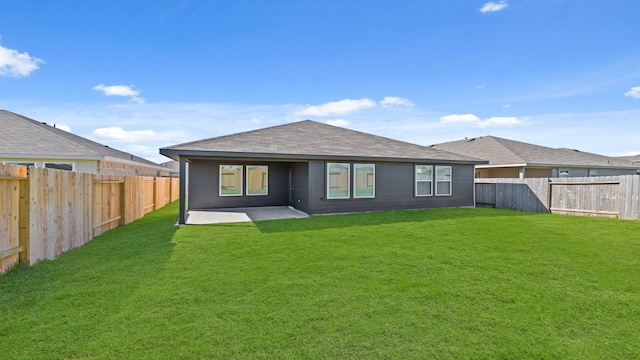 back of house featuring a yard and a patio area