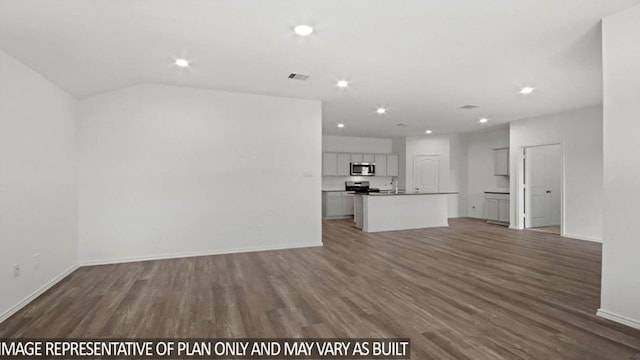 unfurnished living room featuring vaulted ceiling, dark wood-type flooring, and sink