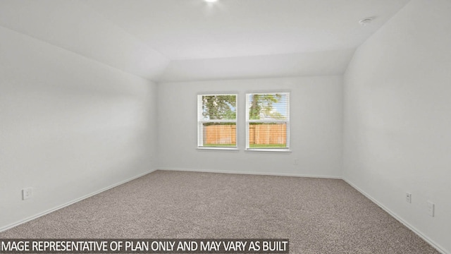 spare room with carpet flooring and vaulted ceiling